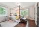 Cozy bedroom with a four-poster bed, hardwood floors, two windows and plenty of natural light at 1135 Timberland Se Dr, Marietta, GA 30067