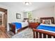 Inviting bedroom with two twin beds, and a wooden floor topped with a beautiful rug at 1135 Timberland Se Dr, Marietta, GA 30067