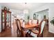 Formal dining room with wood table and chairs under decorative chandelier, open to kitchen at 1135 Timberland Se Dr, Marietta, GA 30067