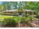 Charming single-story brick home featuring a covered front porch and beautifully landscaped front yard at 1135 Timberland Se Dr, Marietta, GA 30067