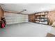 Spacious garage with ample storage space featuring brick walls and a durable gray epoxy floor at 1135 Timberland Se Dr, Marietta, GA 30067