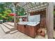 Outdoor hot tub surrounded by a pergola, deck, and patio, offering a private and serene retreat at 1135 Timberland Se Dr, Marietta, GA 30067