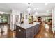 Open concept kitchen with a large island, stainless steel appliances, and adjacent living room at 1135 Timberland Se Dr, Marietta, GA 30067