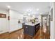 Modern kitchen with large island, white cabinets, stainless steel appliances, and hardwood floors at 1135 Timberland Se Dr, Marietta, GA 30067