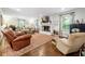 Bright living room with hardwood floors, a brick fireplace, and comfortable seating arrangements at 1135 Timberland Se Dr, Marietta, GA 30067