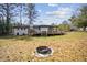 Expansive backyard with wooden deck and fire pit at 3698 Sharon Dr, Powder Springs, GA 30127