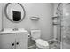 Bathroom with a modern sink vanity and a sleek, glass-enclosed walk-in shower with tiled walls at 3698 Sharon Dr, Powder Springs, GA 30127