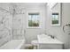 Bathroom featuring modern vanity, new fixtures, and tiled bathtub at 3698 Sharon Dr, Powder Springs, GA 30127