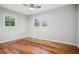 Spacious bedroom with natural light, windows, and beautiful hardwood floors for a warm, inviting ambiance at 3698 Sharon Dr, Powder Springs, GA 30127