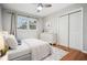 Cozy bedroom featuring hardwood floors, ceiling fan, rug, closet, double windows, dresser, and a comfortable bed at 3698 Sharon Dr, Powder Springs, GA 30127