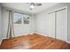 Bright bedroom with hardwood floors, a double window, a ceiling fan, and a closet at 3698 Sharon Dr, Powder Springs, GA 30127