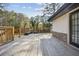 Large wooden deck with railing, built-in benches, and stone accents, offering a great space for outdoor enjoyment at 3698 Sharon Dr, Powder Springs, GA 30127