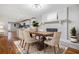 Cozy dining room boasts a brick fireplace, hardwood floors, and an open view to the kitchen at 3698 Sharon Dr, Powder Springs, GA 30127