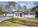 Charming single-story home featuring a freshly painted exterior and a neatly maintained front yard at 3698 Sharon Dr, Powder Springs, GA 30127