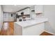 Stylish kitchen features quartz countertops, stainless steel appliances, and a view into the living space at 3698 Sharon Dr, Powder Springs, GA 30127