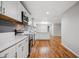 Modern kitchen boasts white cabinets, subway tile backsplash, stainless appliances, and hardwood floors at 3698 Sharon Dr, Powder Springs, GA 30127