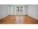 This empty living room features hardwood floors and large windows for lots of natural light at 3698 Sharon Dr, Powder Springs, GA 30127