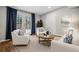 Cozy living room with French doors, white furniture, and natural light creates an inviting atmosphere at 3698 Sharon Dr, Powder Springs, GA 30127