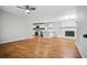 Spacious living room with hardwood floors, open floor plan, and a brick fireplace at 3698 Sharon Dr, Powder Springs, GA 30127