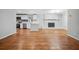 Open-concept living space with hardwood floors, modern kitchen, and cozy fireplace feature at 3698 Sharon Dr, Powder Springs, GA 30127