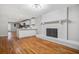 Open-concept living space boasts refinished hardwood floors, updated kitchen, and brick fireplace at 3698 Sharon Dr, Powder Springs, GA 30127