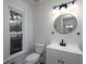 Bright half bathroom features a modern vanity with stylish lighting, and an updated window at 742 Olde Towne Ln, Marietta, GA 30068