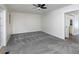 Spacious living area with neutral color palette and ceiling fan and view into next room at 742 Olde Towne Ln, Marietta, GA 30068