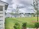Backyard view of charming two-story homes with a lush green lawn at 1177 Chastain Dr, Sugar Hill, GA 30518