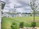 Backyard view of charming two-story homes with a lush green lawn at 1177 Chastain Dr, Sugar Hill, GA 30518