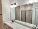 Bathroom featuring double sink vanity with a modern faucet and large mirror at 1177 Chastain Dr, Sugar Hill, GA 30518