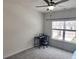 This bedroom features neutral paint, carpet, a ceiling fan, and a large window at 1177 Chastain Dr, Sugar Hill, GA 30518