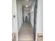 Open entryway with gray wood floors, white walls, and stainless steel refrigerator at 1177 Chastain Dr, Sugar Hill, GA 30518