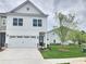 Charming two-story home with a two-car garage and a well-manicured lawn at 1177 Chastain Dr, Sugar Hill, GA 30518