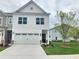 Charming two-story home with a two-car garage and a well-manicured lawn at 1177 Chastain Dr, Sugar Hill, GA 30518