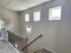 Bright upstairs hallway featuring natural light from accent windows and access to bedrooms at 1177 Chastain Dr, Sugar Hill, GA 30518
