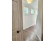 Bright hallway with gray wood floors, white walls, and natural light at 1177 Chastain Dr, Sugar Hill, GA 30518