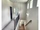 Upstairs hallway with carpet, a railing, and three accent windows providing natural light at 1177 Chastain Dr, Sugar Hill, GA 30518