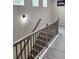 Carpeted hallway showcasing a staircase with decorative railing, plus a hallway accent light and artwork at 1177 Chastain Dr, Sugar Hill, GA 30518