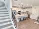 Open concept kitchen with an island featuring seating, modern appliances, and access to the staircase at 1177 Chastain Dr, Sugar Hill, GA 30518