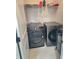 The laundry room boasts a modern washer and dryer on tile flooring at 1177 Chastain Dr, Sugar Hill, GA 30518