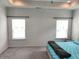 Bright main bedroom with neutral walls, carpet flooring, and a tray ceiling at 1177 Chastain Dr, Sugar Hill, GA 30518