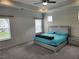 Spacious main bedroom with a ceiling fan, tray ceiling, carpet and lots of natural light at 1177 Chastain Dr, Sugar Hill, GA 30518