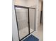 Bathroom with a glass enclosed shower, tiled walls, and black trim at 1177 Chastain Dr, Sugar Hill, GA 30518