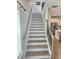 Staircase with hardwood steps and metal railing, leading to the upper level of the home at 1177 Chastain Dr, Sugar Hill, GA 30518