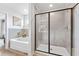 Modern bathroom showcasing a glass enclosed shower and a soaking tub at 2078 Brookhill Way, Snellville, GA 30078