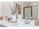 Bathroom vanity featuring double sinks, chrome faucets, and elegant decor at 2078 Brookhill Way, Snellville, GA 30078