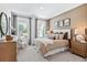 Comfortable bedroom features neutral decor, plush bedding, and abundant natural light at 2078 Brookhill Way, Snellville, GA 30078