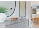 An entryway decor featuring a round mirror and a textured painting at 2078 Brookhill Way, Snellville, GA 30078