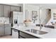 Bright kitchen island with stainless steel appliances, seating, and modern faucet at 2078 Brookhill Way, Snellville, GA 30078