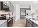 Stylish kitchen features gray cabinets, stainless appliances, and ample counter space at 2078 Brookhill Way, Snellville, GA 30078